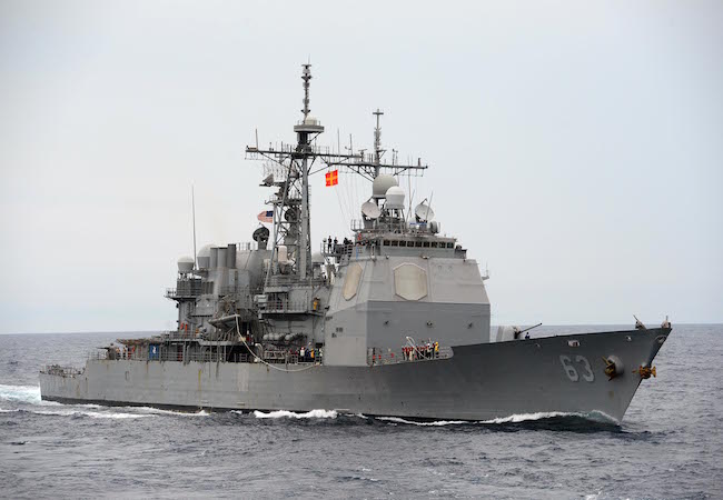 The guided-missile cruiser USS Cowpens (CG 63) maneuvers into position during a replenishment-at-sea. Cowpens is on patrol with the George Washington Carrier Strike Group in the U.S. 7th Fleet area of responsibility supporting security and stability in the Indo-Asia-Pacific region. (Photo by Mass Communication Specialist 3rd Class Declan Barnes: Courtesy of US Navy/WikiCommons)